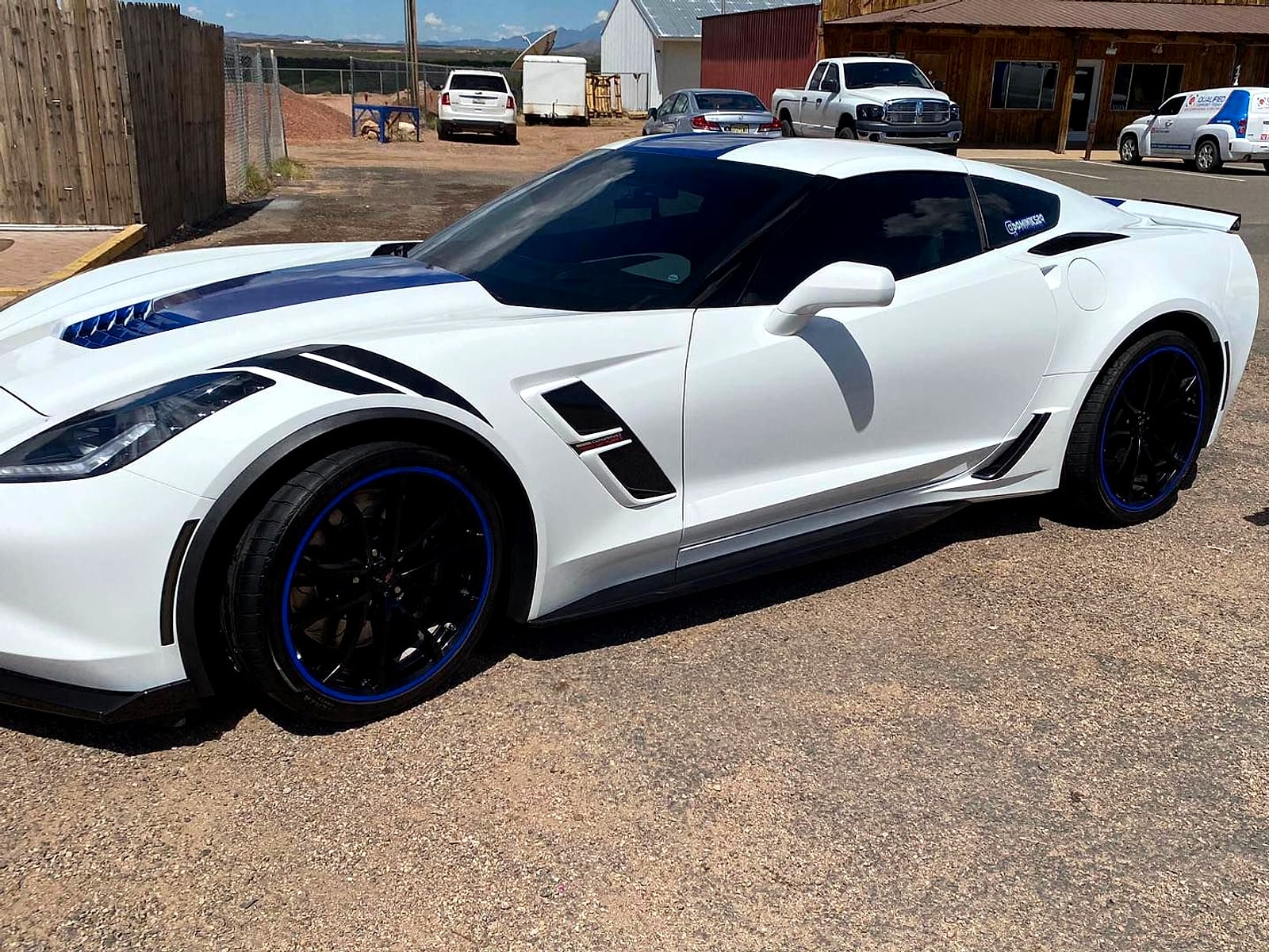 White Corvette with blue stripes after a detail