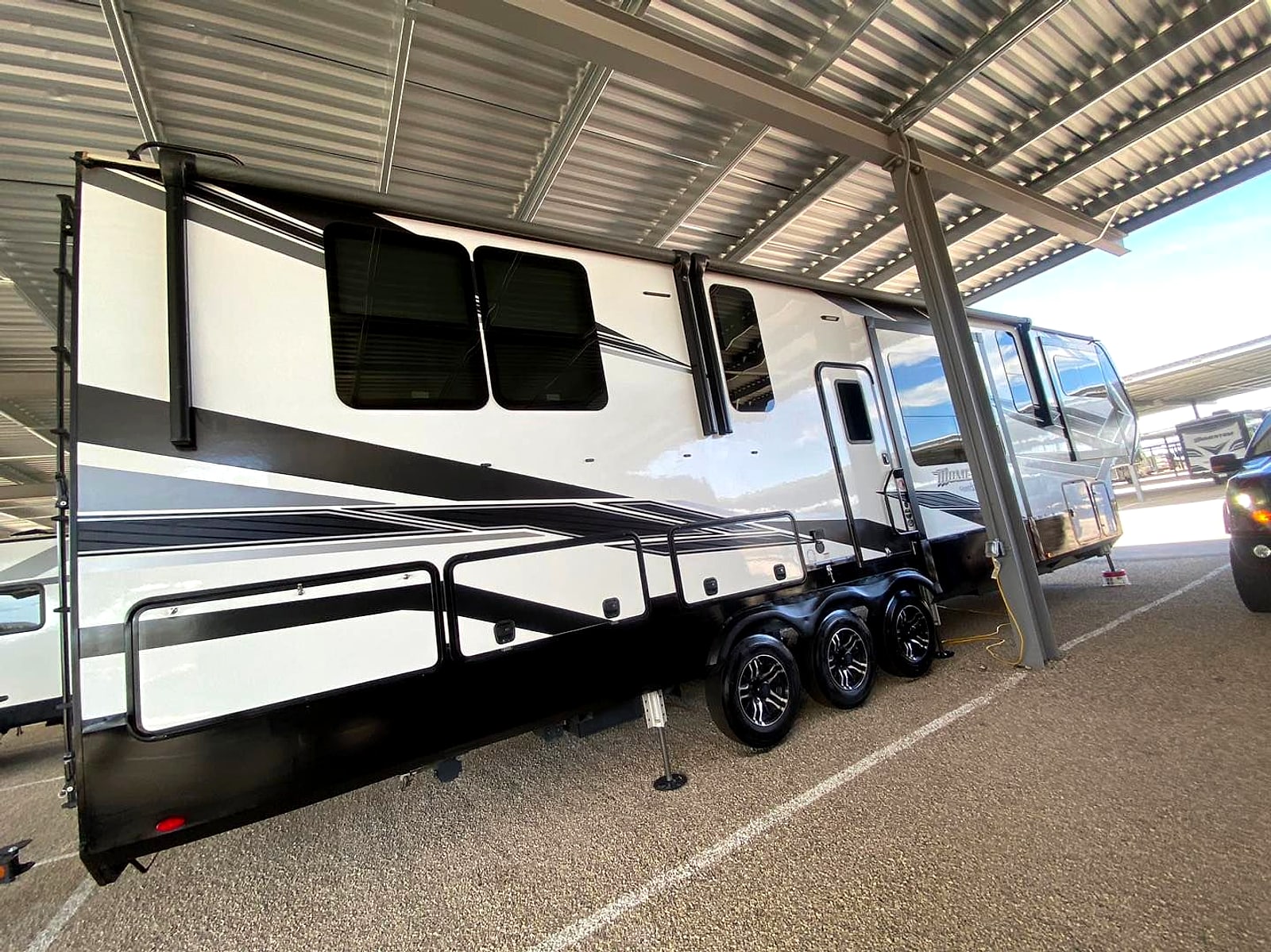 Travel trailer camper parked under the shade canopy